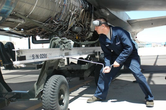 Military worker repairing a plane